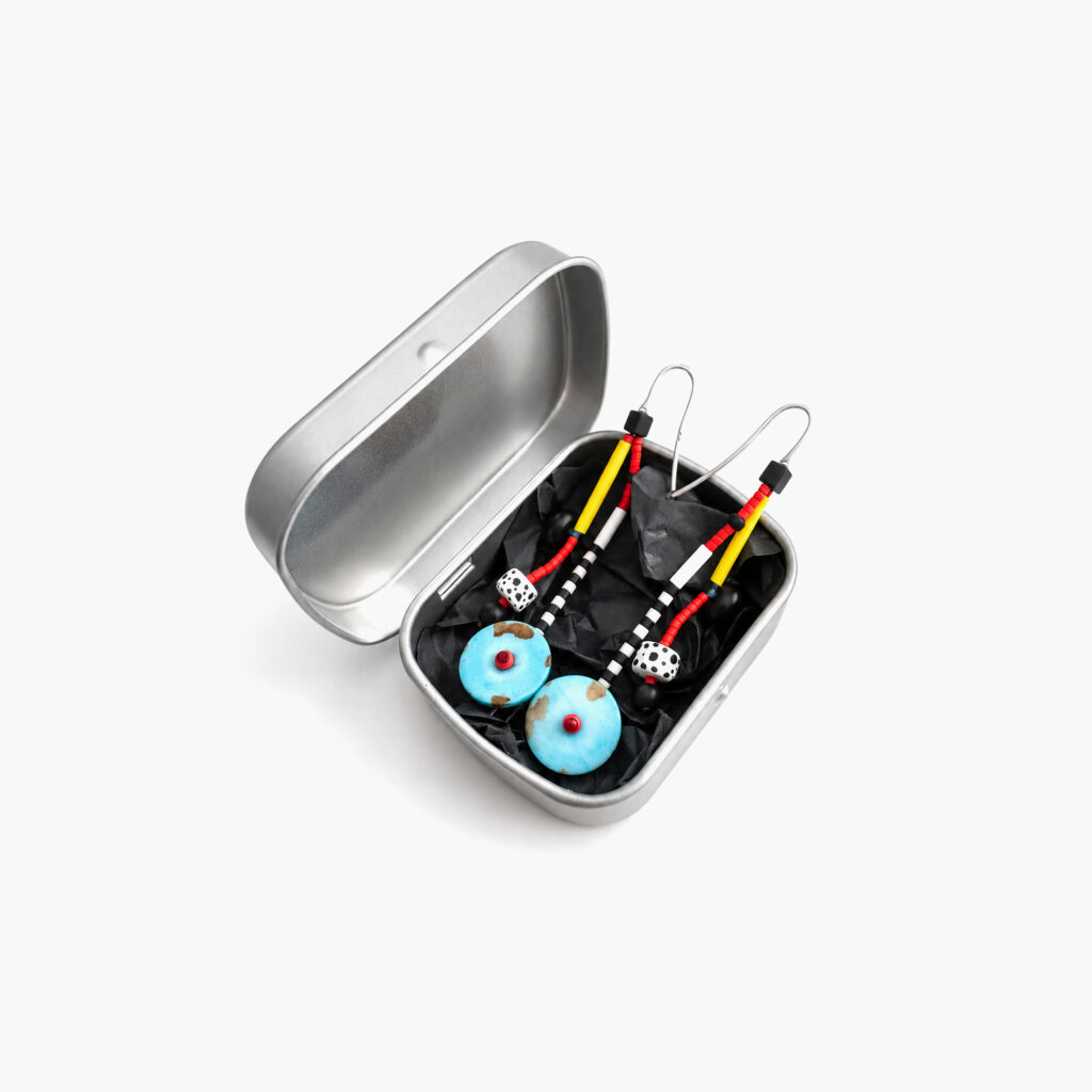 Turquoise beaded earrings presented in a metal gift box