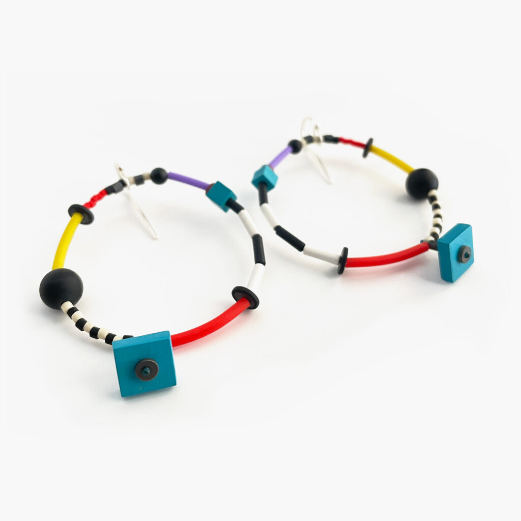 Colorful geometric beaded hoop earrings on white background