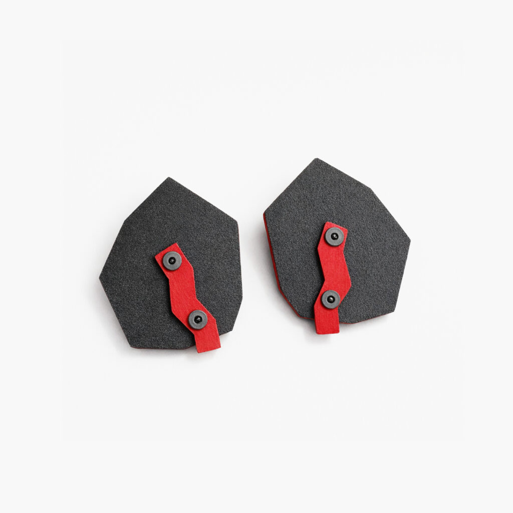 Black red industrial geometric wooden earrings with angular forms and exposed hardware on a white background