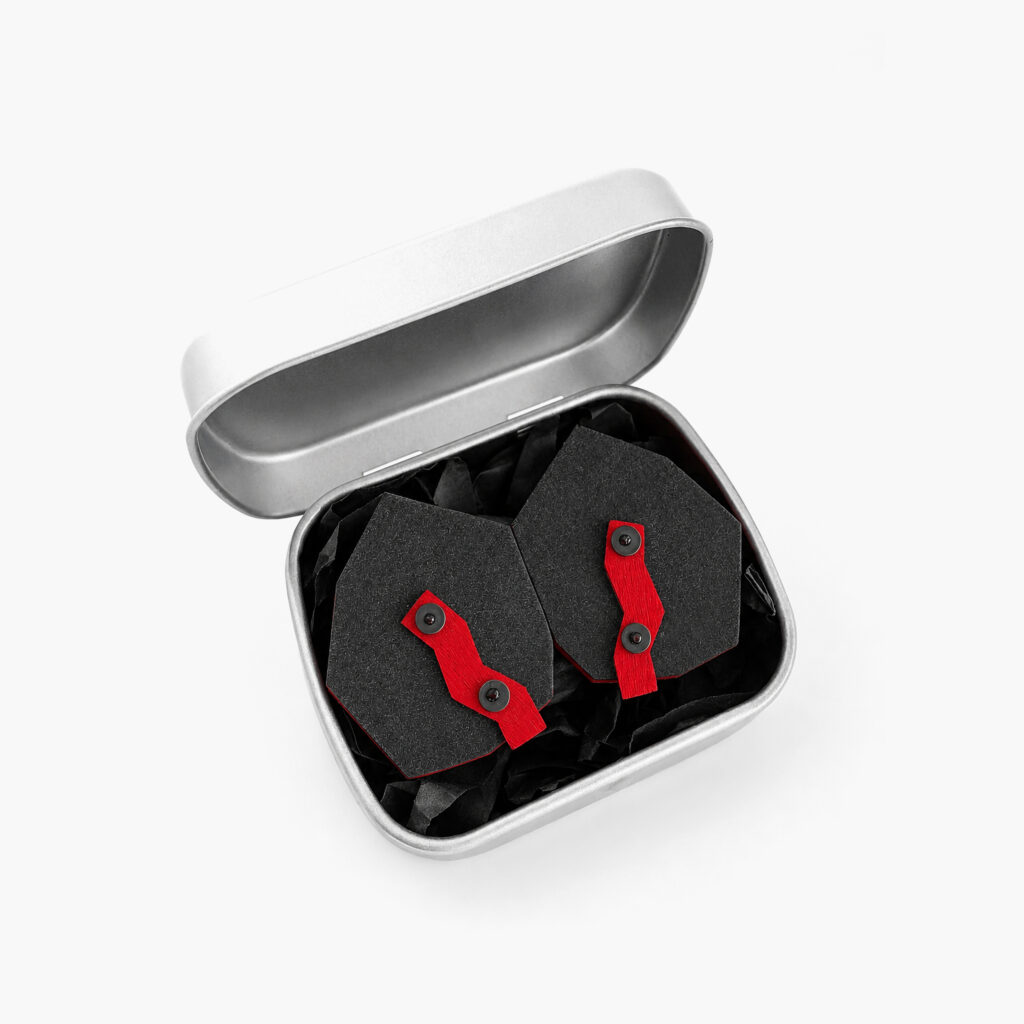 Black red geometric wooden earrings presented in a metal gift box