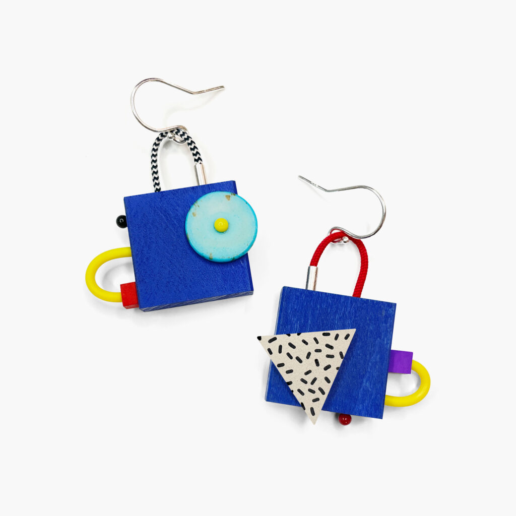 Colorful mismatched geometric wooden earrings with blue squares and turquoise circular details