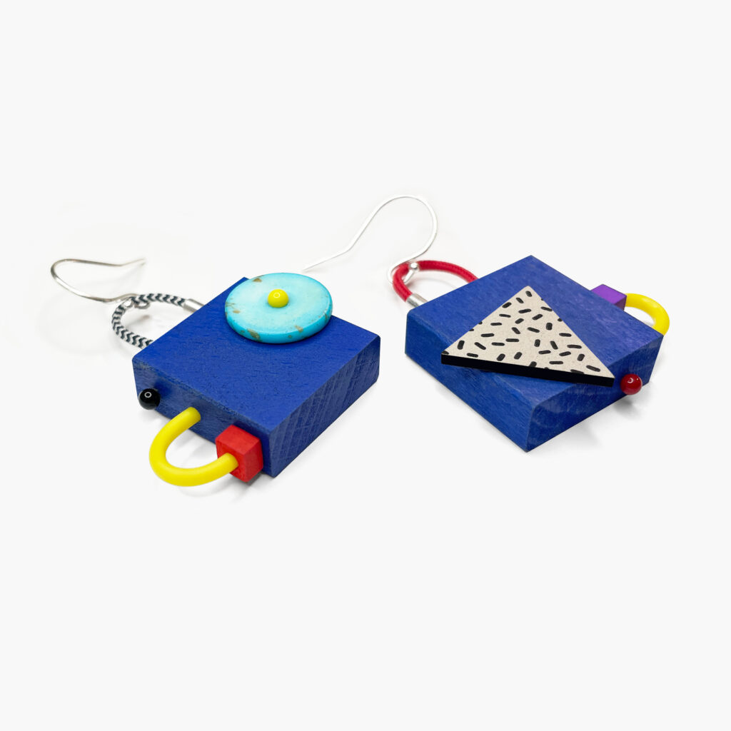 Blue mismatched wooden earrings with layered geometric elements – angled view