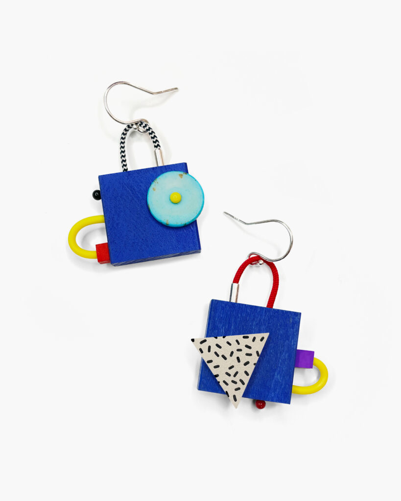 Colorful mismatched geometric wooden earrings with blue squares and turquoise circular details