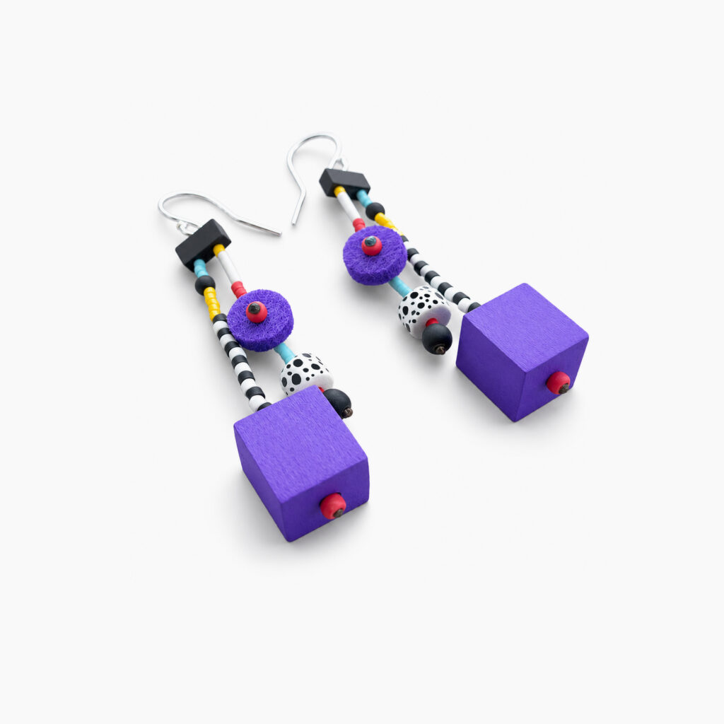 Pair of purple geometric statement earrings with multicolored beads on white background