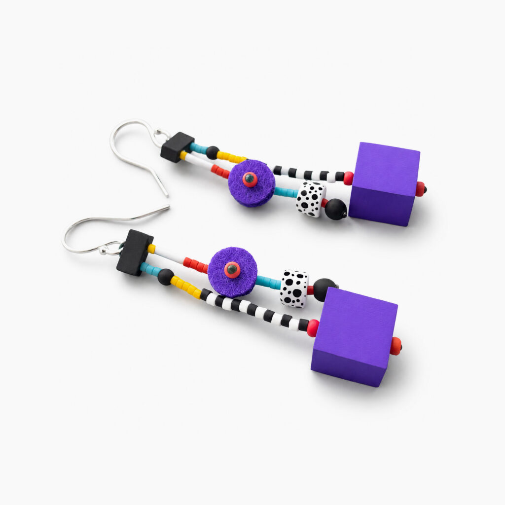 Purple geometric dangle earrings with black and white patterned beads – side view