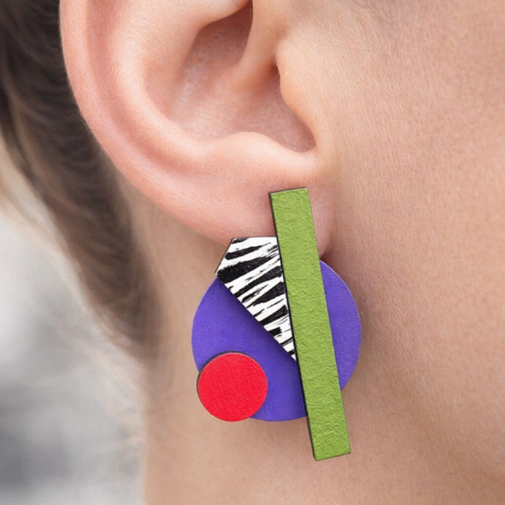 Colorful geometric wooden earring worn on the ear