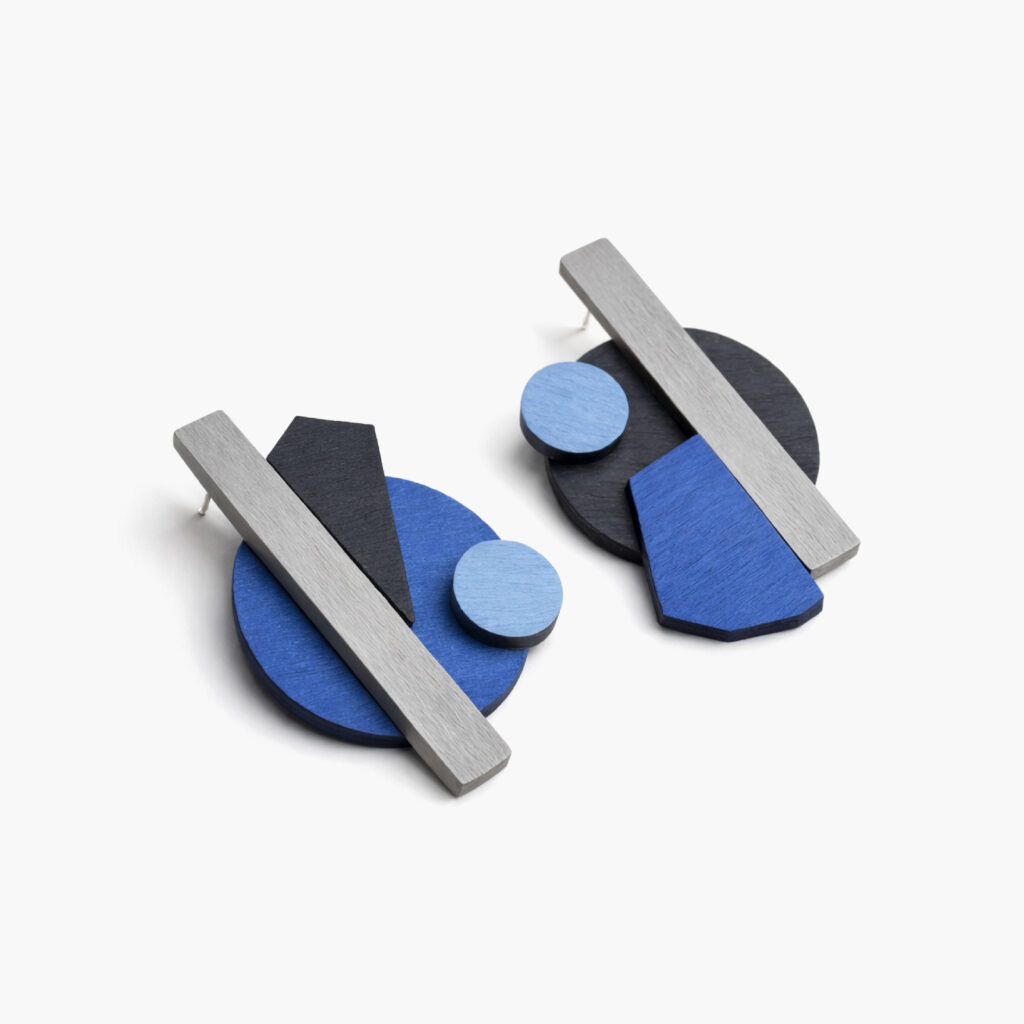 Abstract blue and black statement earrings with layered geometric shapes – angled view