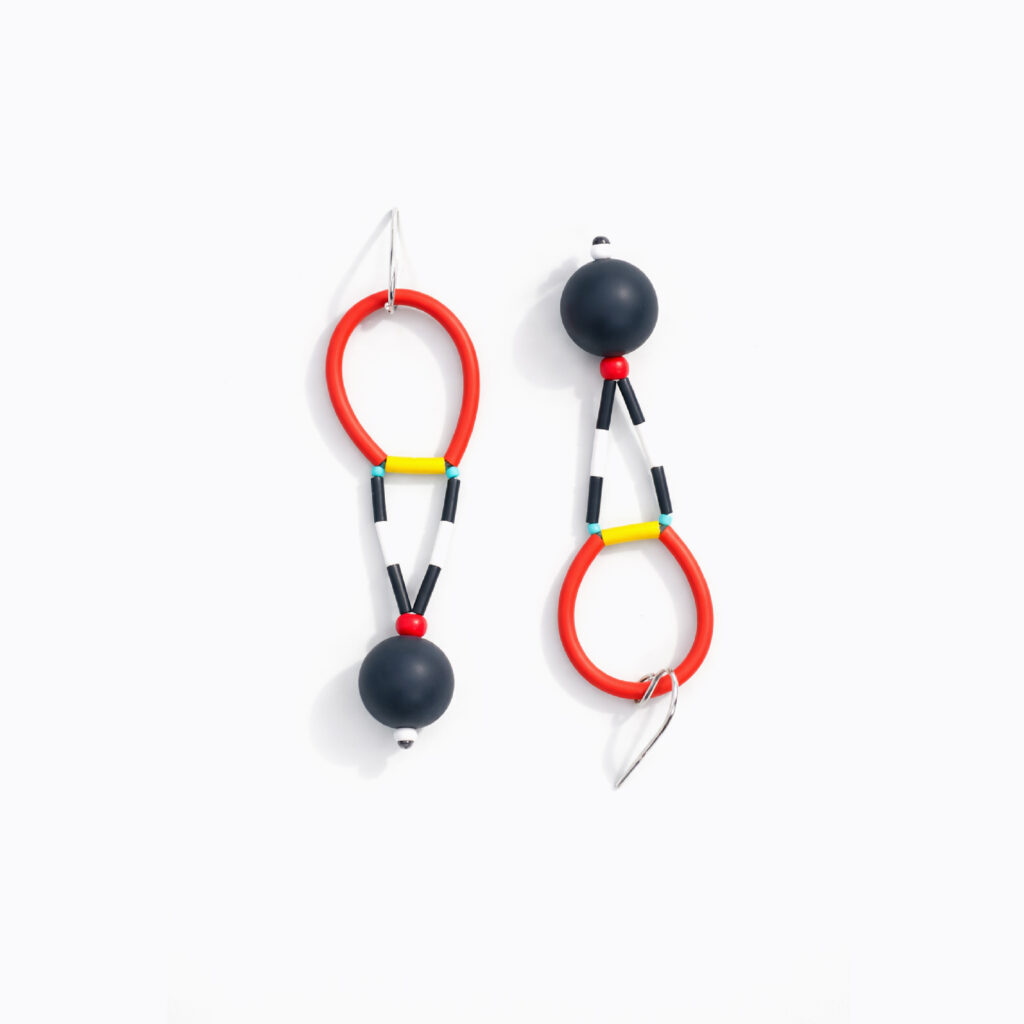 Asymmetrical red and black statement earrings with elongated geometric details
