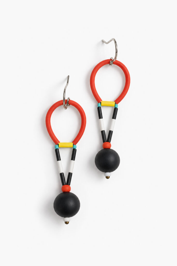 Asymmetrical red and black statement earrings with elongated geometric details