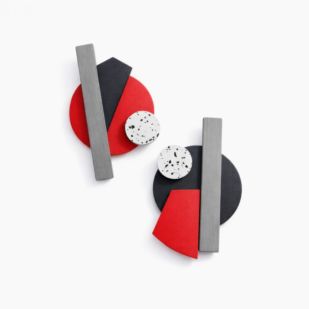 Asymmetrical statement earrings with red and black shapes and silver-grey bars