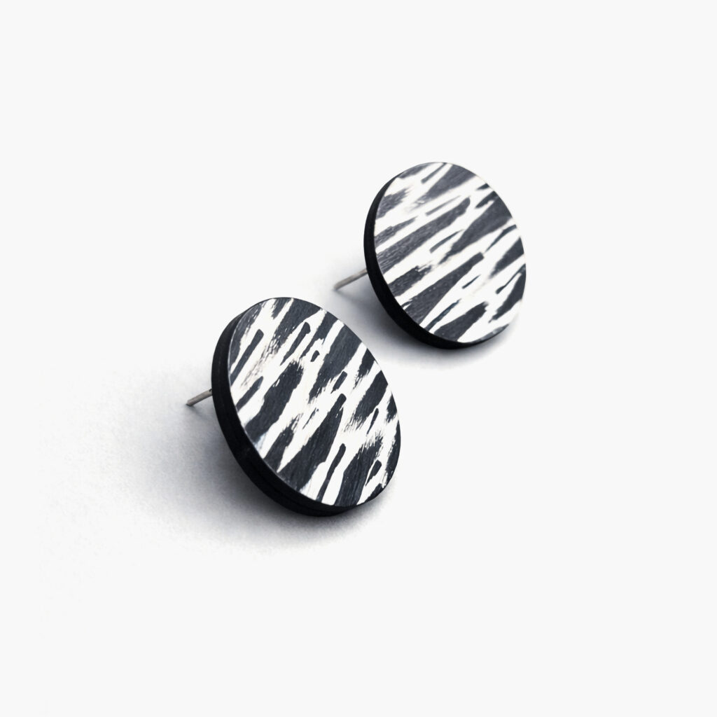 Large round wooden stud earrings with bold black and white graphic patterns