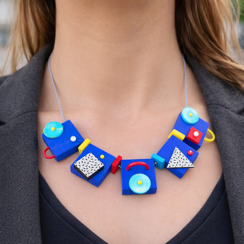 Blue memphis geometric wooden statement necklace worn with a dark top