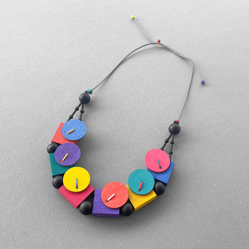 Multicolor geometric statement necklace with adjustable gray cord
